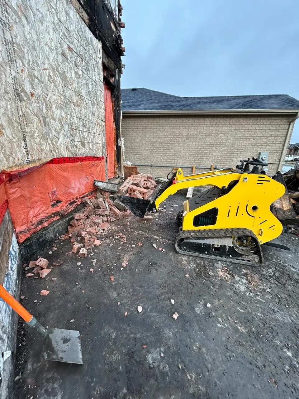 Our mini stand-on track loader at a brick-removal job site in the GTA.